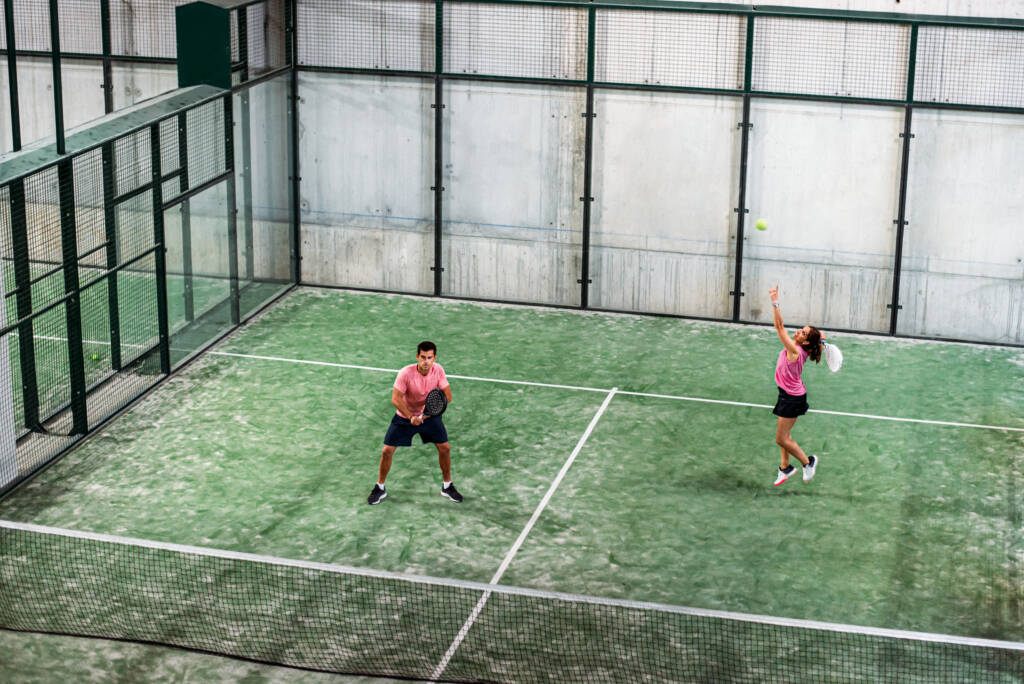 mixed padel match in a padel court indoor