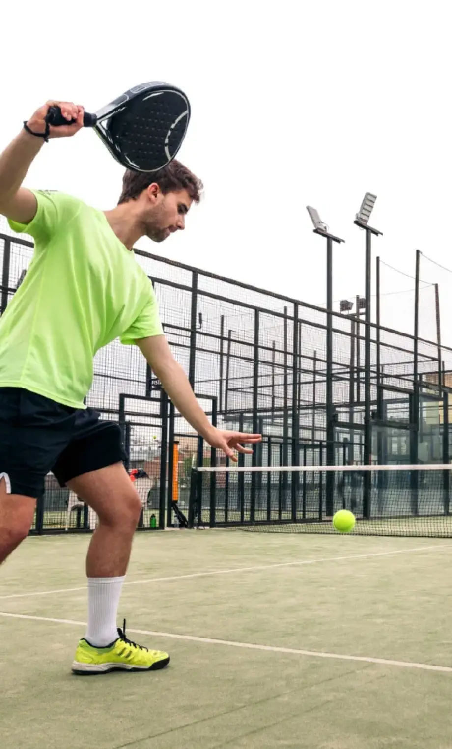 young-man-serving-paddle-tennis-game-scaled